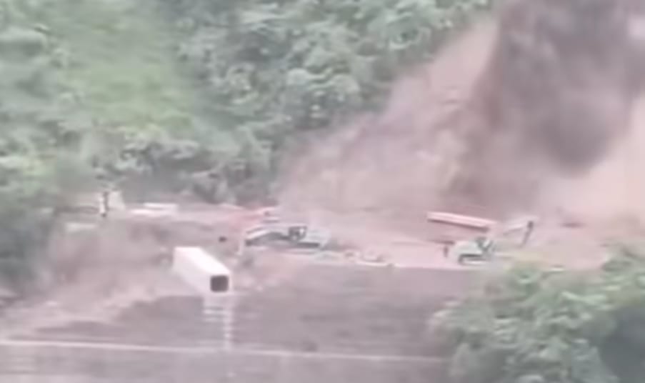 Hillside cracks due to four-lane construction at Bhararighat; bus has a narrow escape.