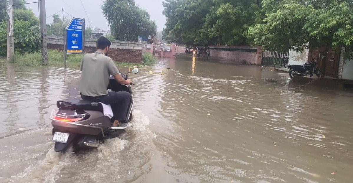 Heavy rain causes waterlogging in the city and disrupts normal life, bringing relief from the heat.