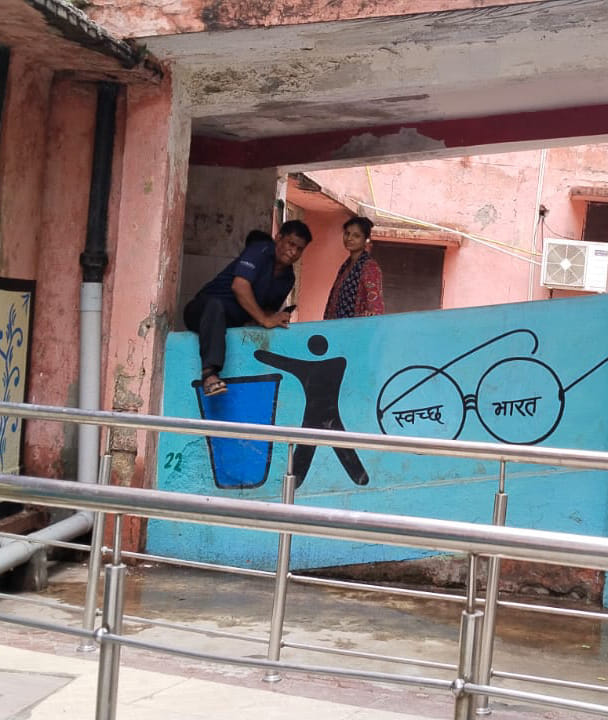 Dilapidated building causes difficulties; patients are climbing over railings to reach the lab.