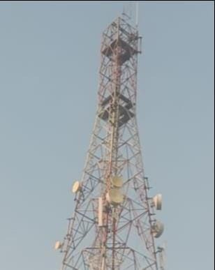 Youth climbed a tower demanding an overbridge; came down after his wife persuaded him.