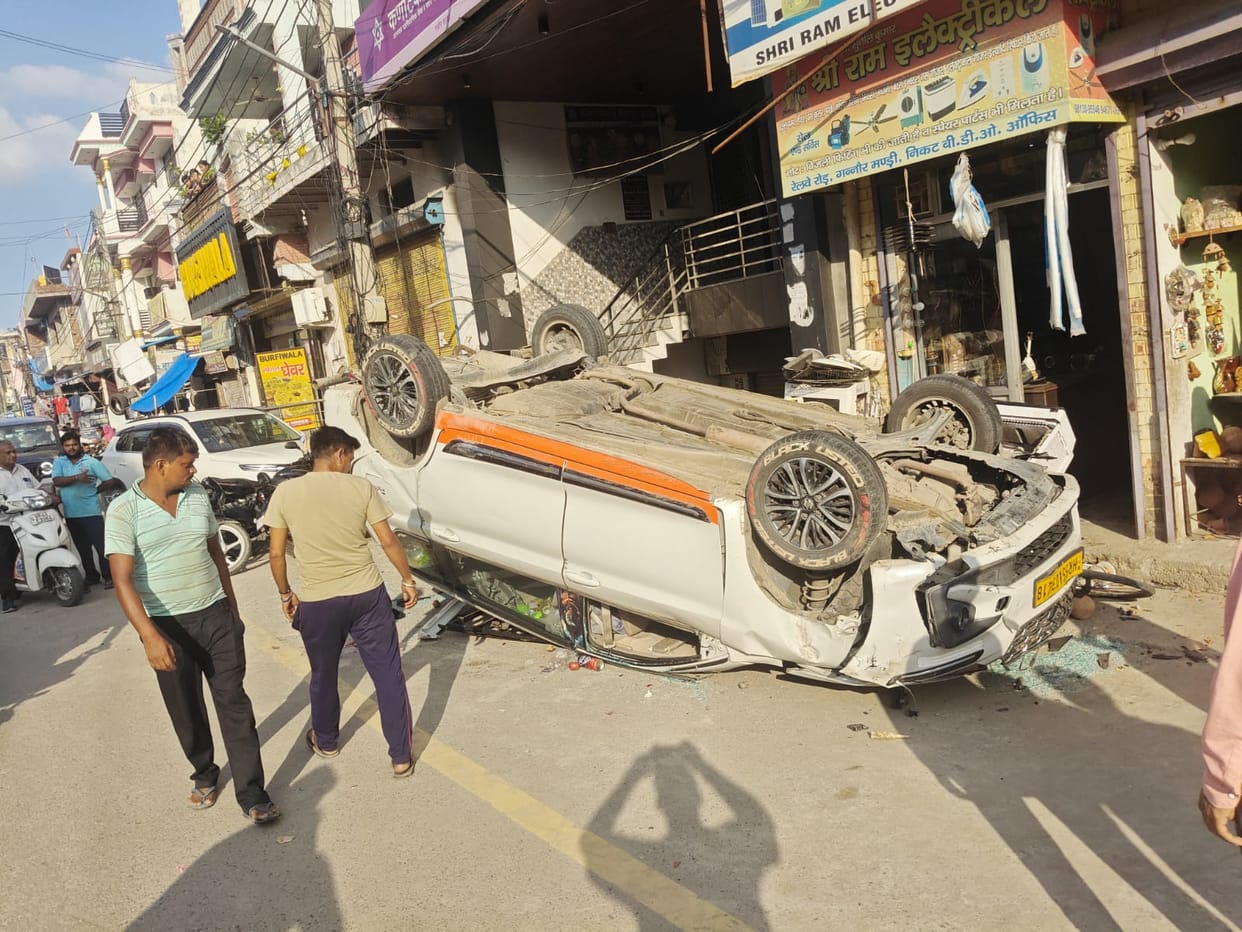 Speeding vehicle overturns; motorcyclist and mechanic injured.