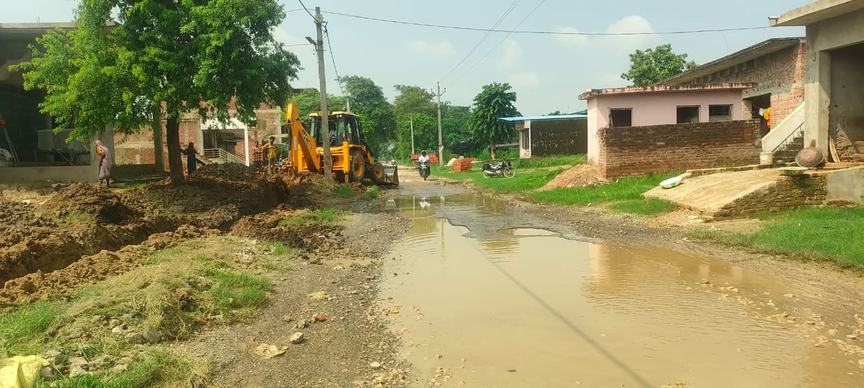 The PWD initiated the excavation of the drain using a JCB.