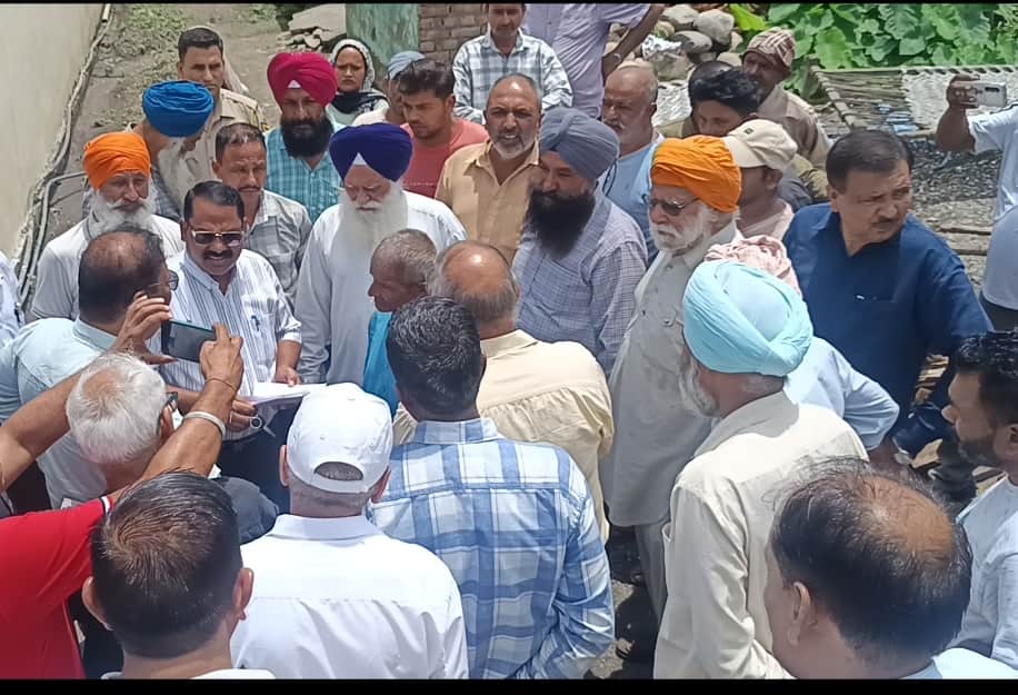 Team arrives to remove encroachment following court order; villagers protest.