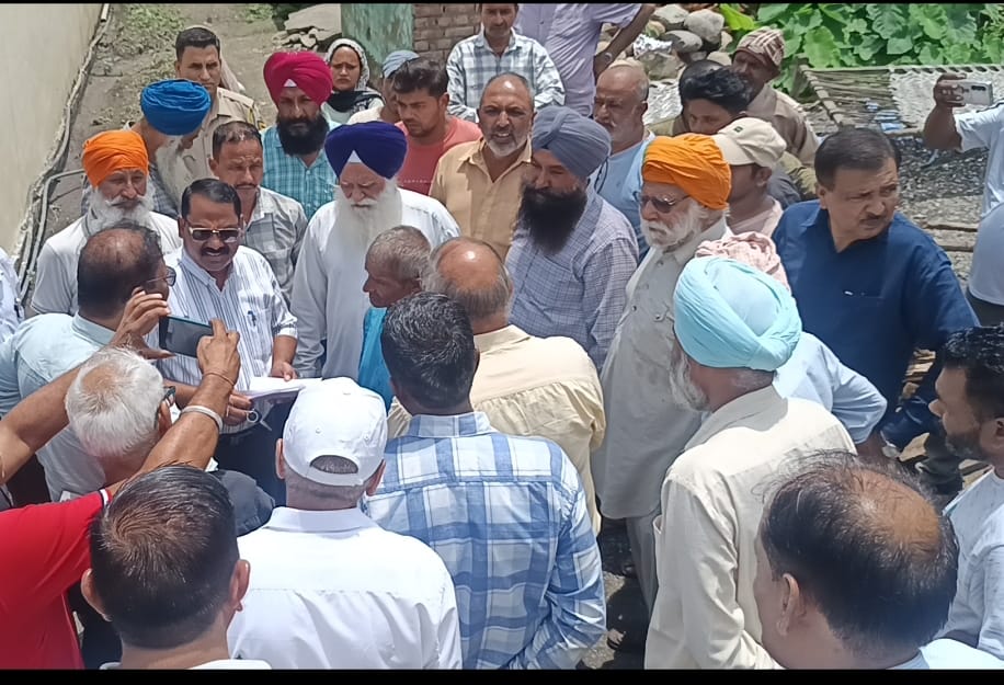 Team arrives to remove encroachment following court order; villagers protest.