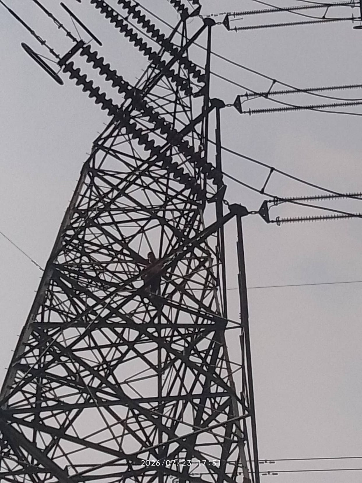 Youth climbs high-tension tower to seek justice for his sister