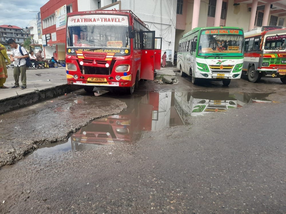 Just a little rain and the bus stand turns into a pond.