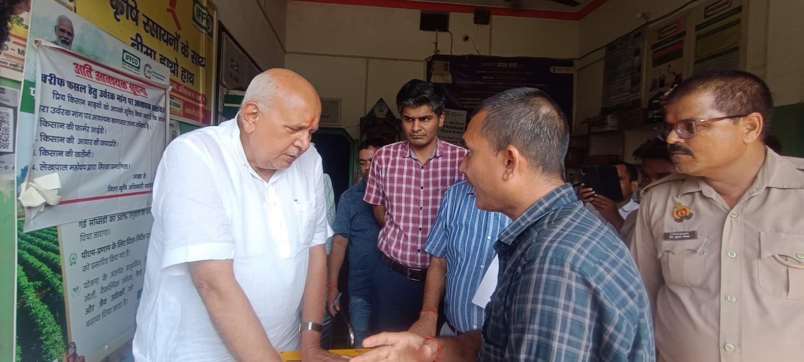 समिति में सचिव से बात करते कृषि मंत्री।
