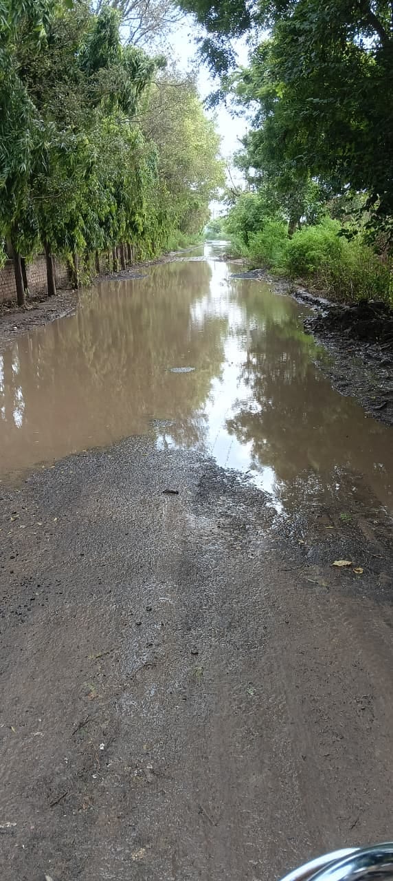 Water everywhere on the road in the martyr's village.