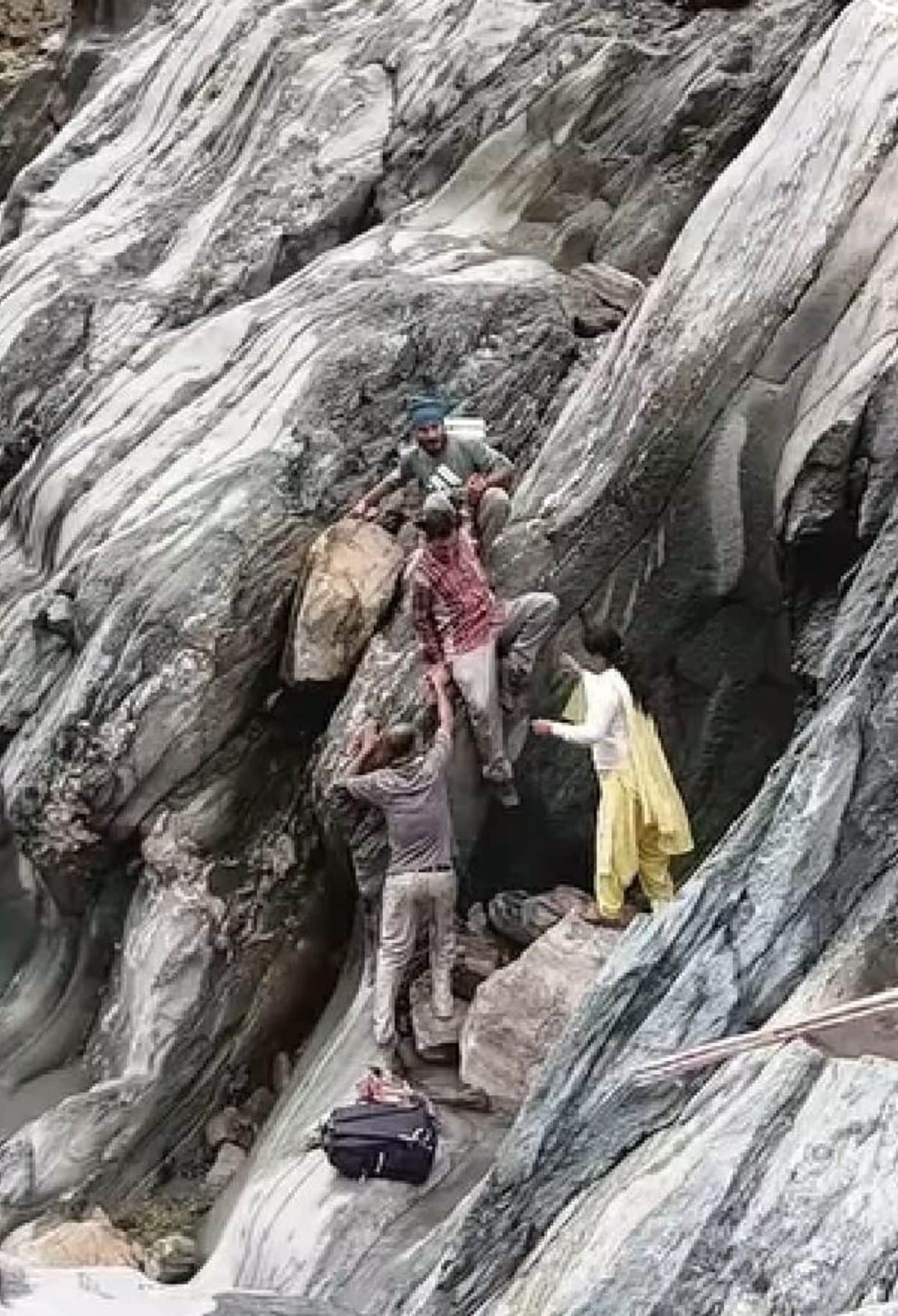 ढलानदार चट्टान से नीचे उतरतेधिमला पंचायत के कलेला गांव  केग्रामीण। संवाद