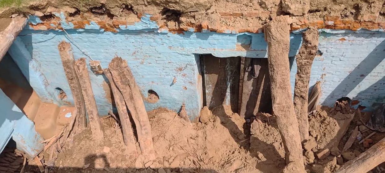 Father dies trapped under debris after mud roof collapses; son injured.