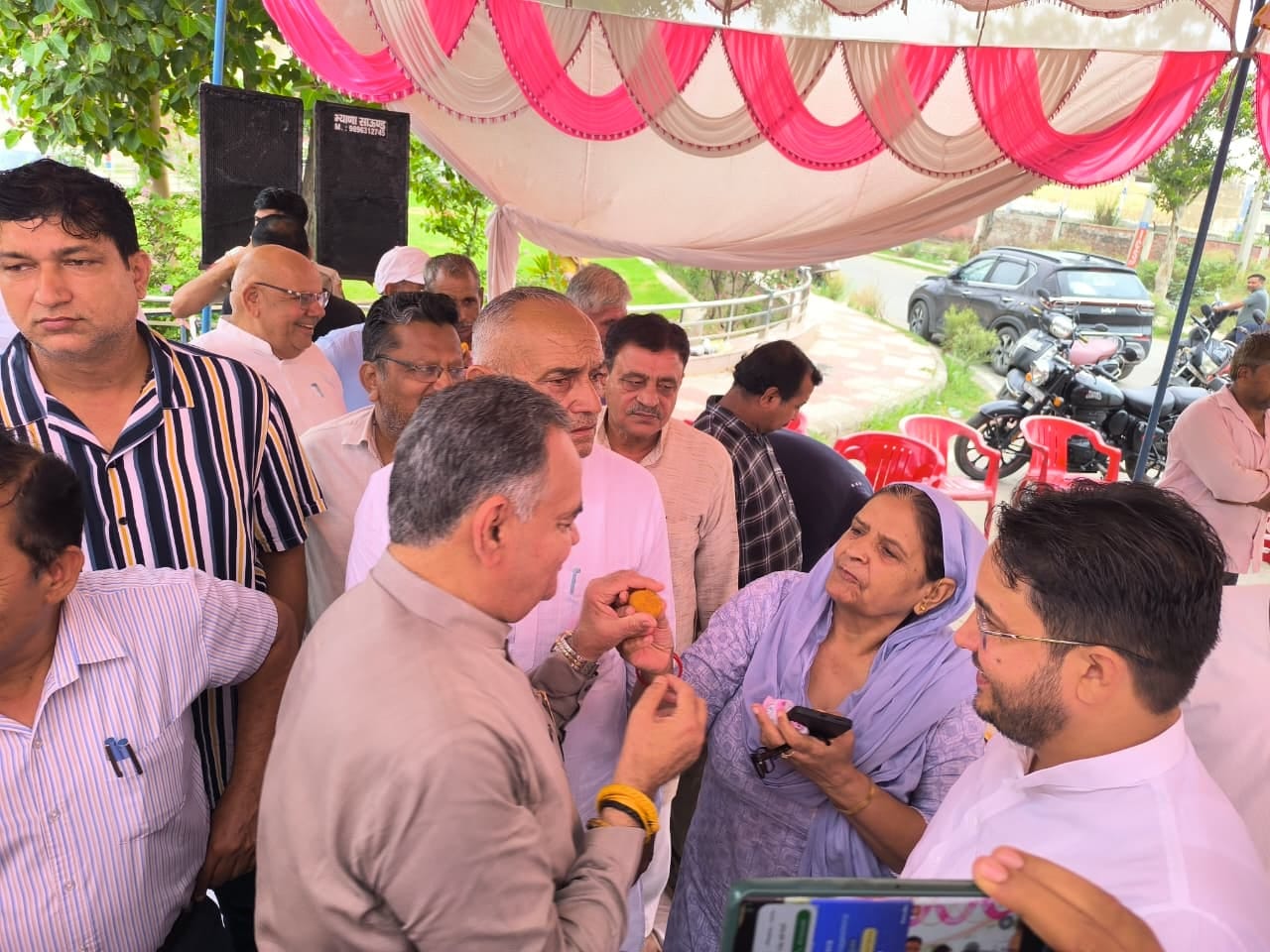 मांग पूरी होने की खुशी में धरनास्थल पर विधायक विनोद भयाना को लड्डू खिलातीं महिला। प्रशासन