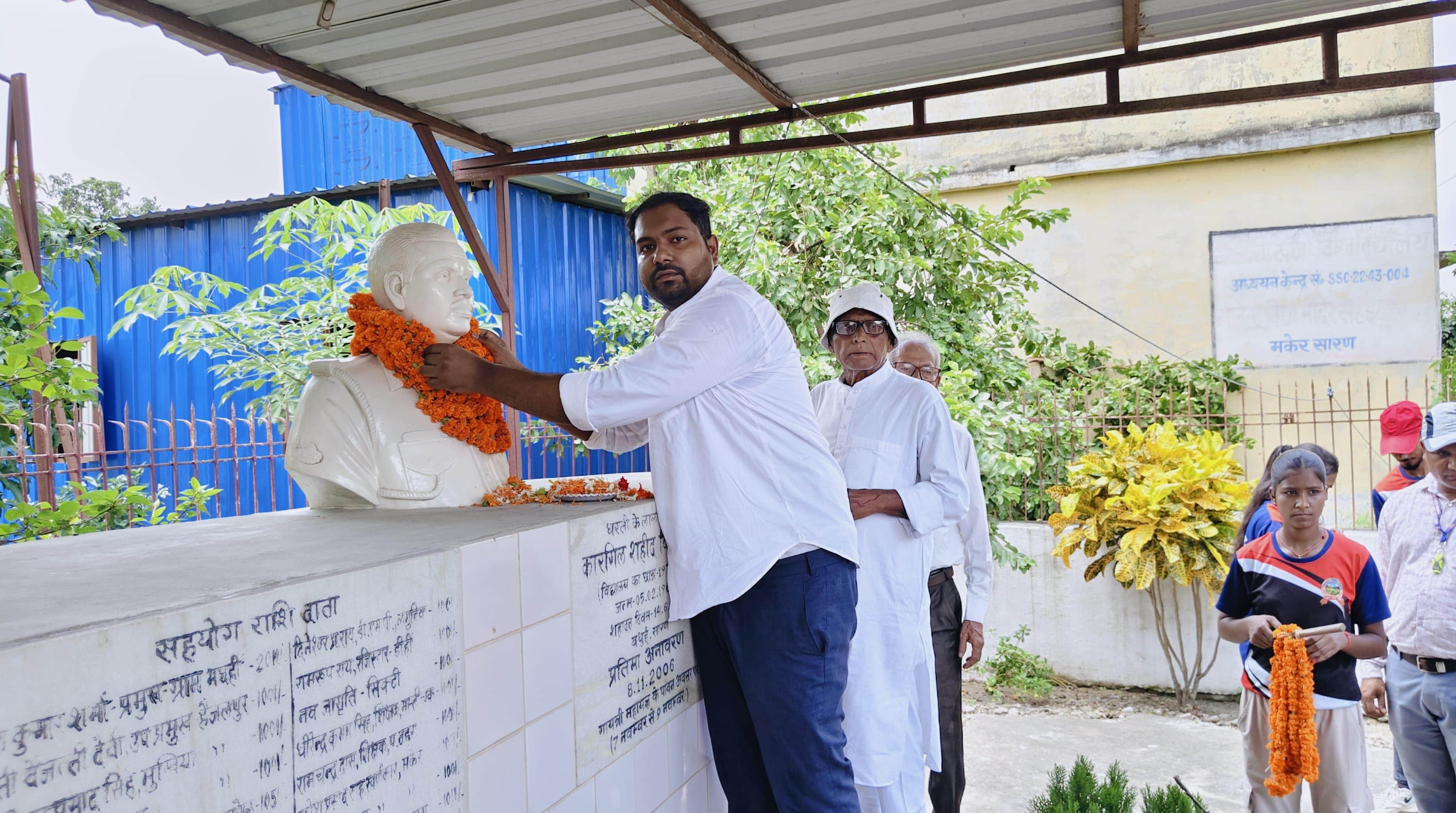 शहीद को श्रद्धांजलि अर्पित करते पुत्र रविश राज व अन्य गणमान्य लोग
