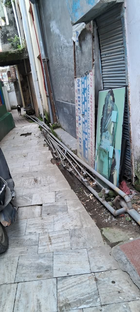 Pipes laid over drains have not been removed even after a month and a half; public resentment grows.