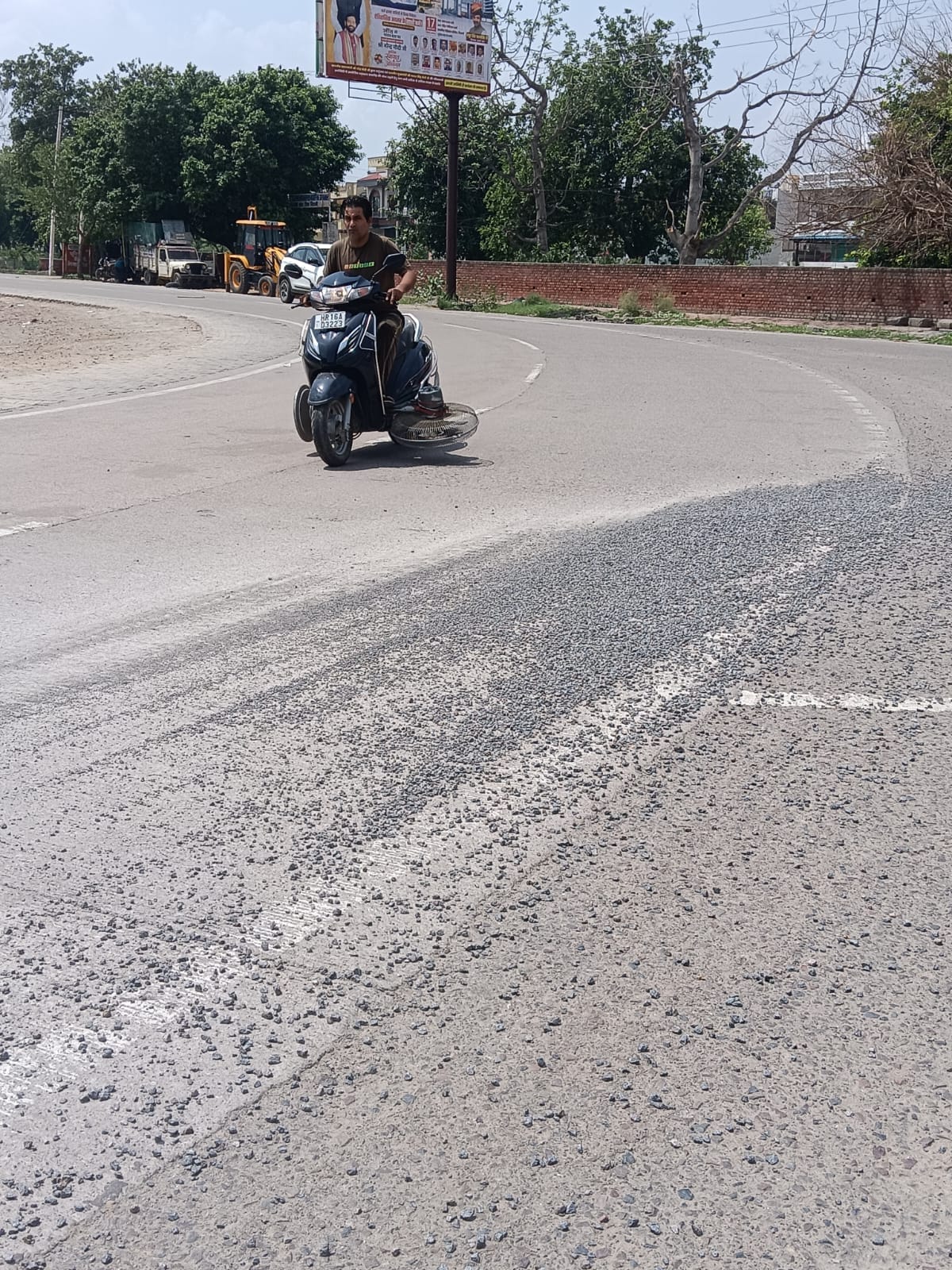 Lives entangled in piles of gravel; the threat of an accident looms at the sharp turn.