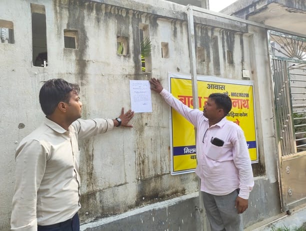 Health Department pastes notice at Baba Gorakhnath Centre.