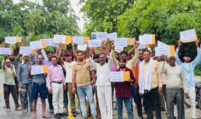 Encroachment on village community land sparks public outrage; protest held.