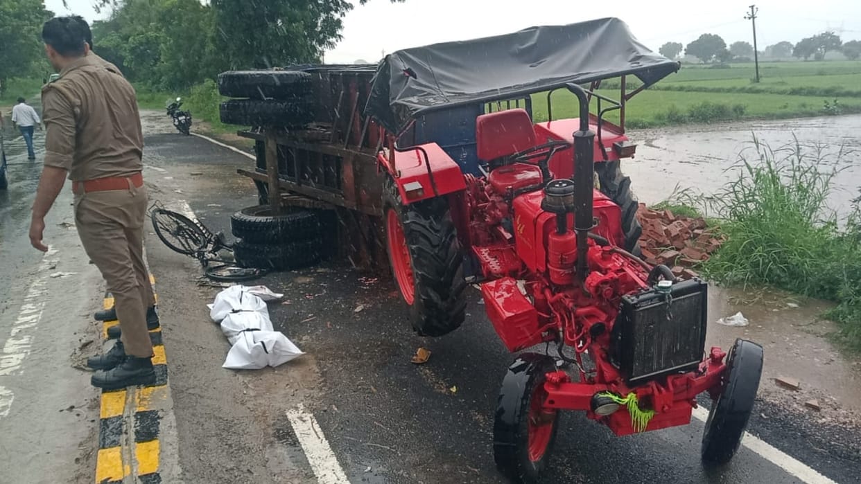 Tractor loaded with bricks overturns on a farmer riding a bicycle; he dies.