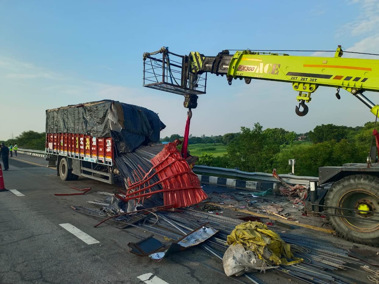 Truck loaded with iron rods crashes after driver dozes off; two injured.