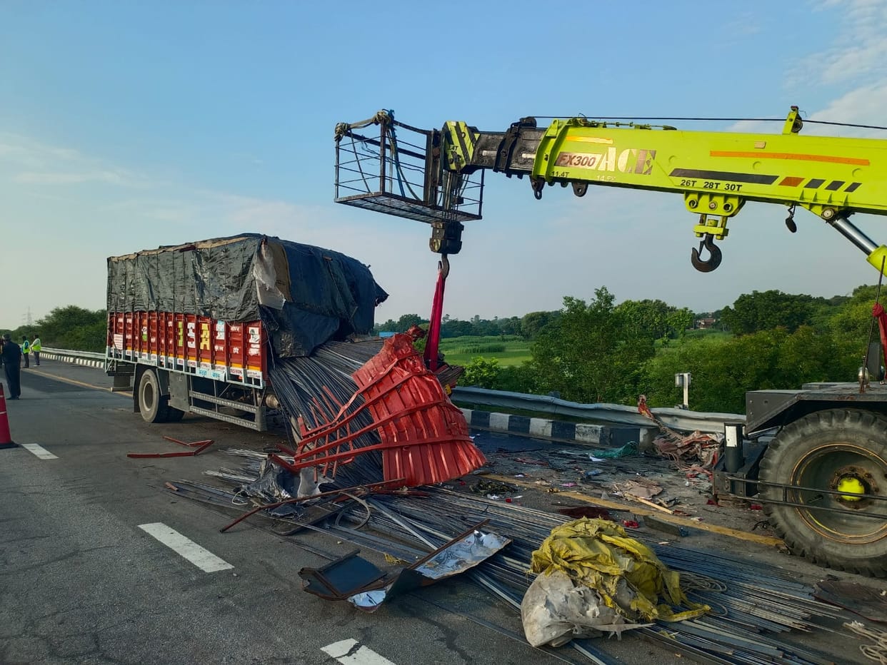 Truck loaded with iron rods crashes after driver dozes off; two injured.