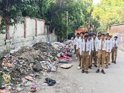 District Magistrate Sir, please have the garbage removed from in front of my children's college.