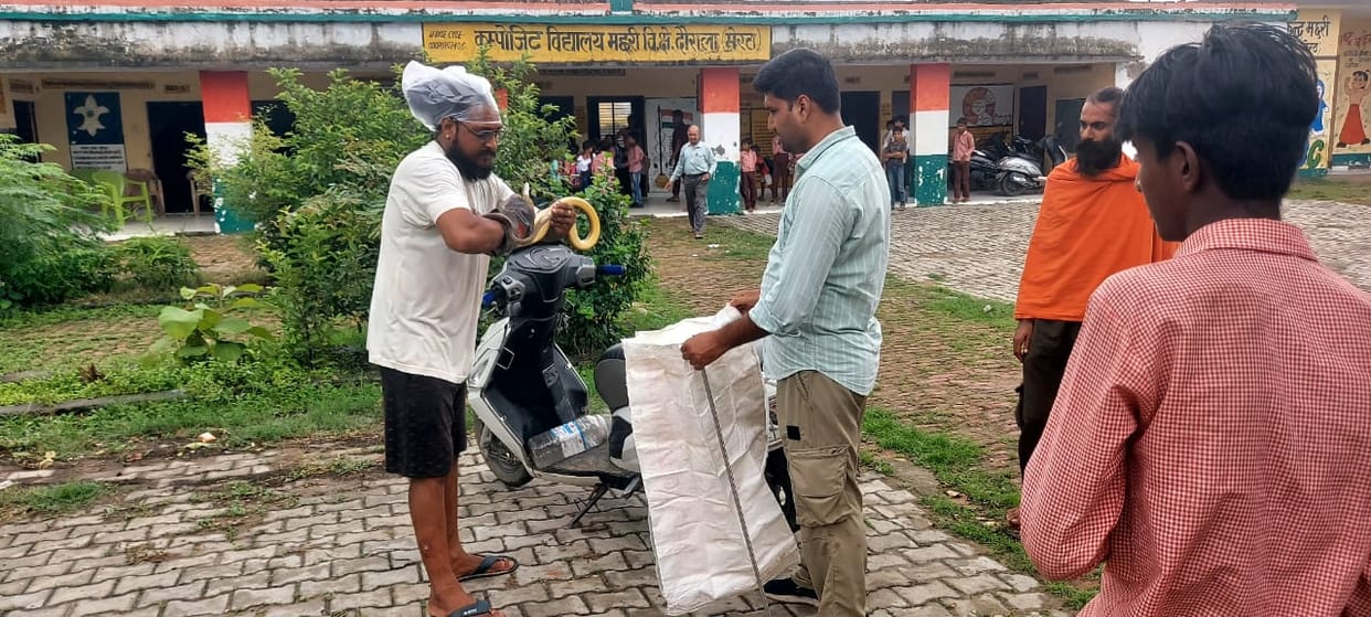 Snake found in composite school; snake rescuer catches it.