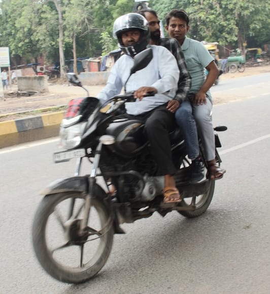 Three people on a two-wheeler: a risk to life.