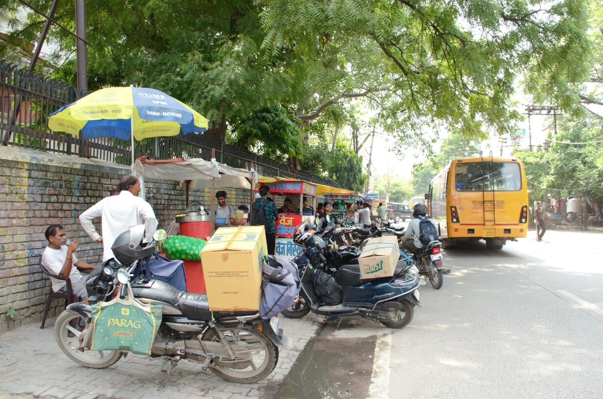 Encroachment on the footpath, pedestrians on the road.