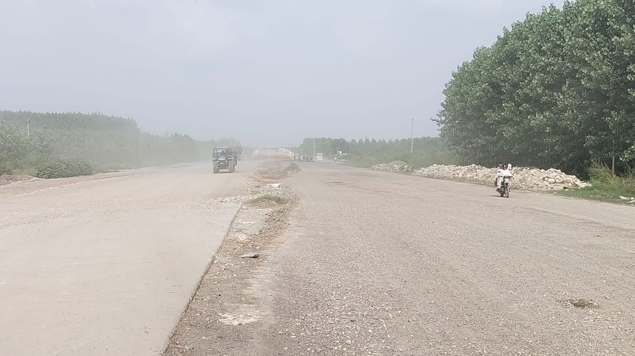Dust rising from the under-construction highway has become a nuisance.