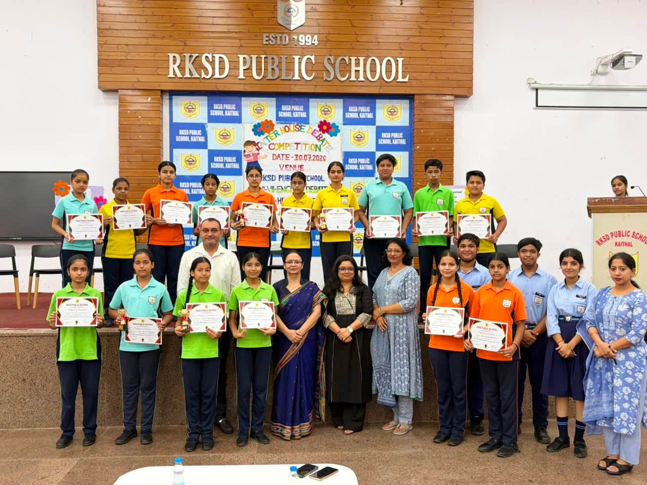 विजेता विद्यार्थियों के साथ स्टाफ सदस्य। विज्ञप्ति