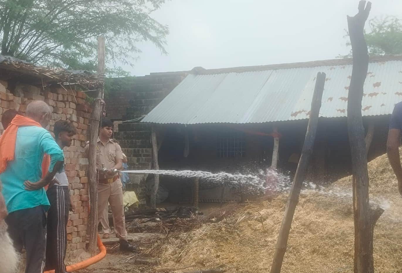 आग बुझाते दमकल कर्मी व मौजूद पुलिस। स्रोत: दमकलकर्मी