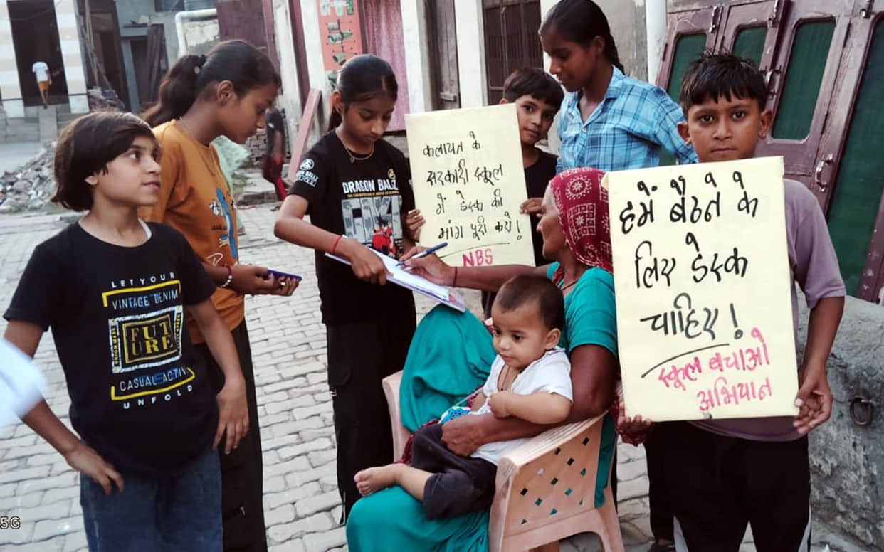 A signature campaign has been launched to demand benches and desks for the girls' school.