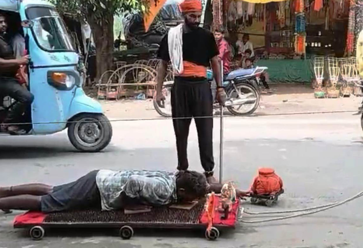 Devotees of Shiva set out performing full-body prostrations on a trolley fitted with spikes.