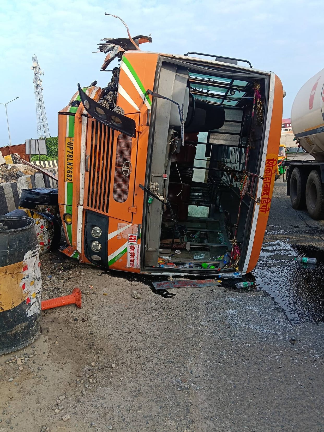 Bus mounts divider while overtaking a truck.