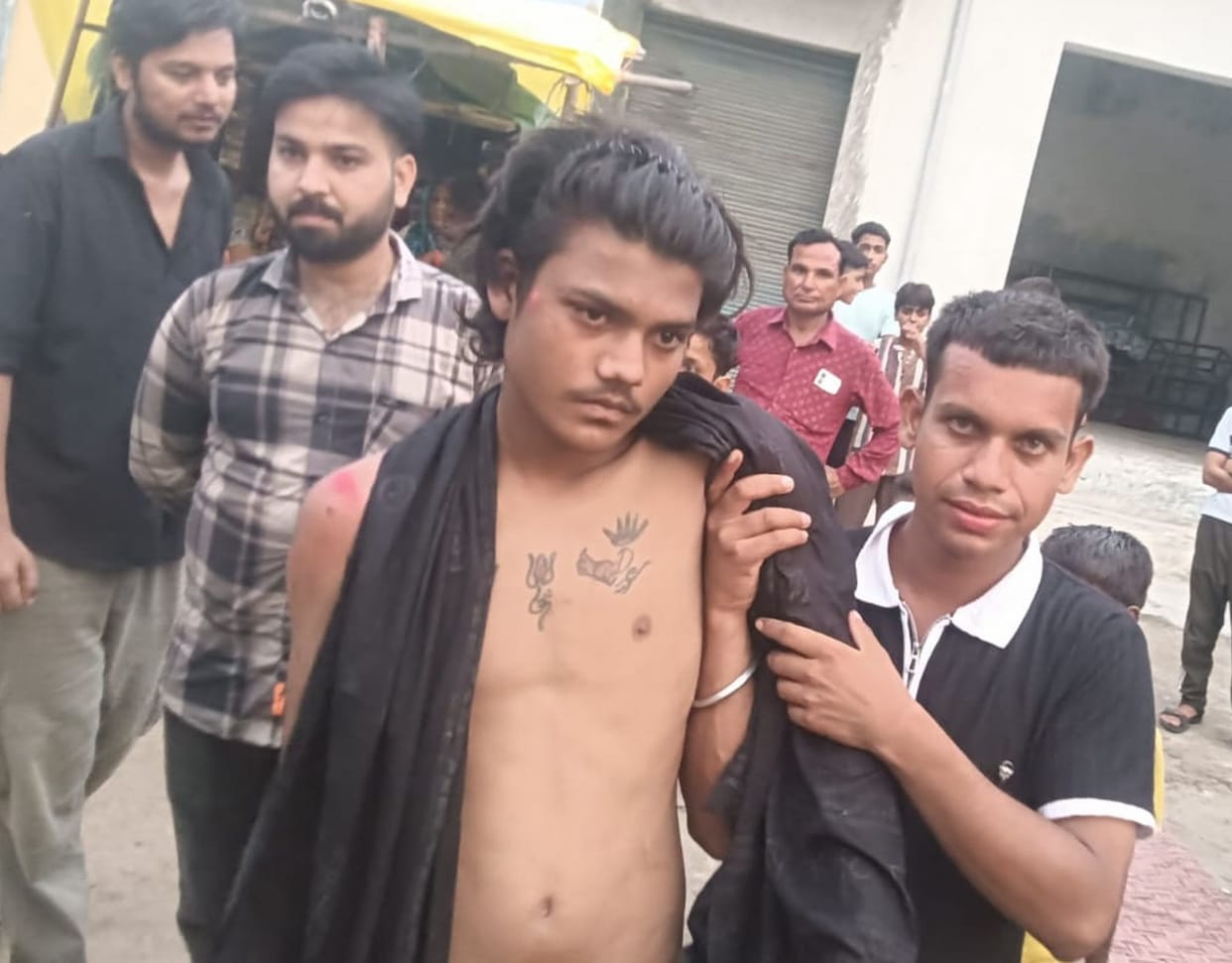 Kanwariya on a scooter carrying holy water injured after colliding with cattle.