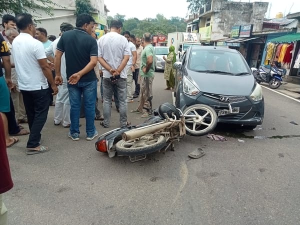 Car and bike collide in Rakkar market; father and daughter injured.