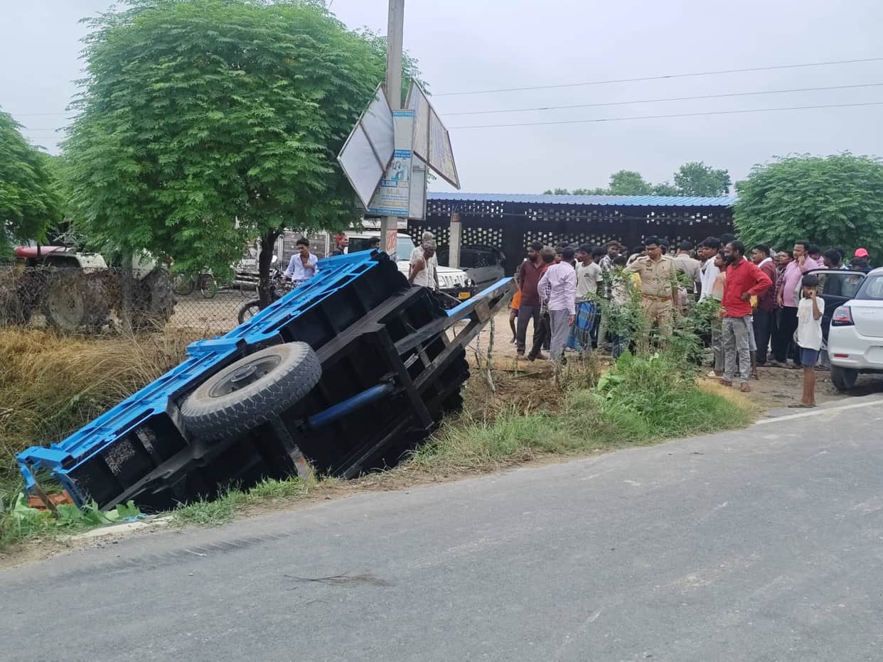 Tractor overturns after hitting railing; driver injured.
