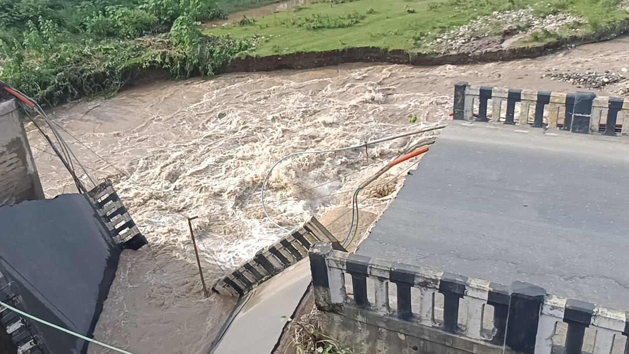 Old bridge collapses into Bata River; a section comes crashing down.