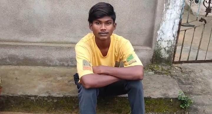 A young man was found hiding under a cot; people caught him and handed him over to the police.