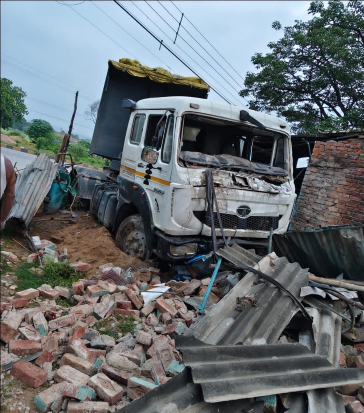 Out-of-control trailer wrecks shops; son of former village head, who was sleeping at home, pulled out from the debris