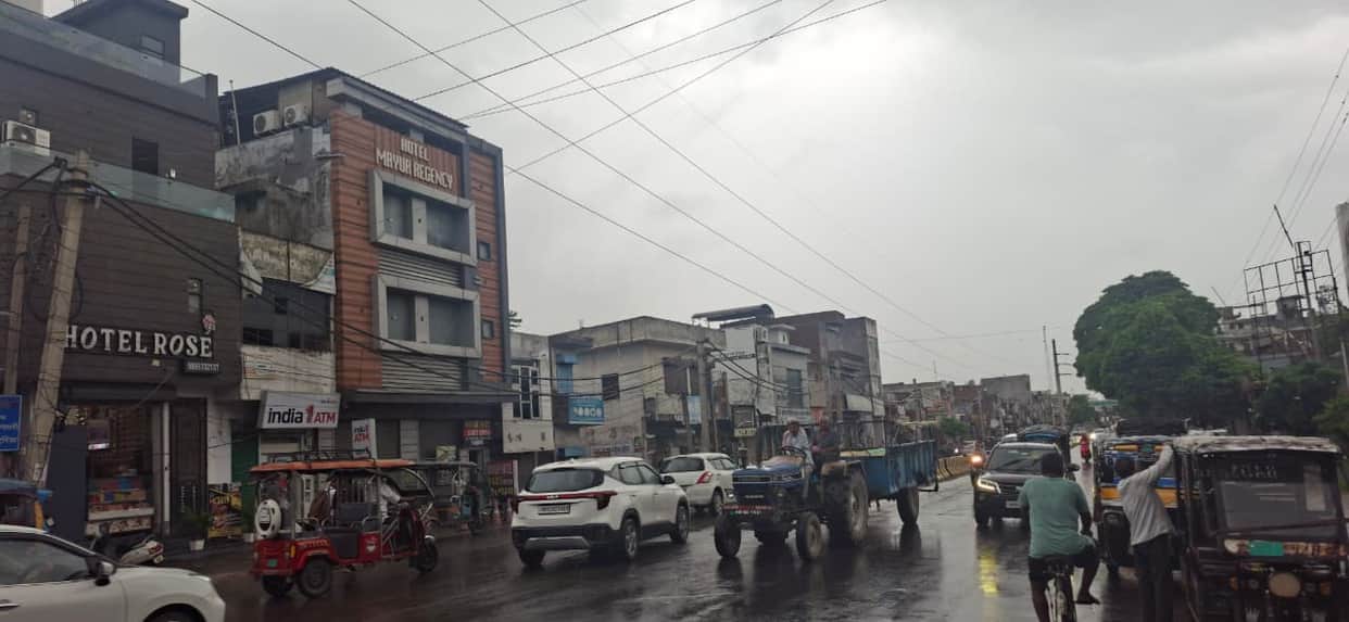 Rainwater accumulates along roadsides; temperature drops by three degrees