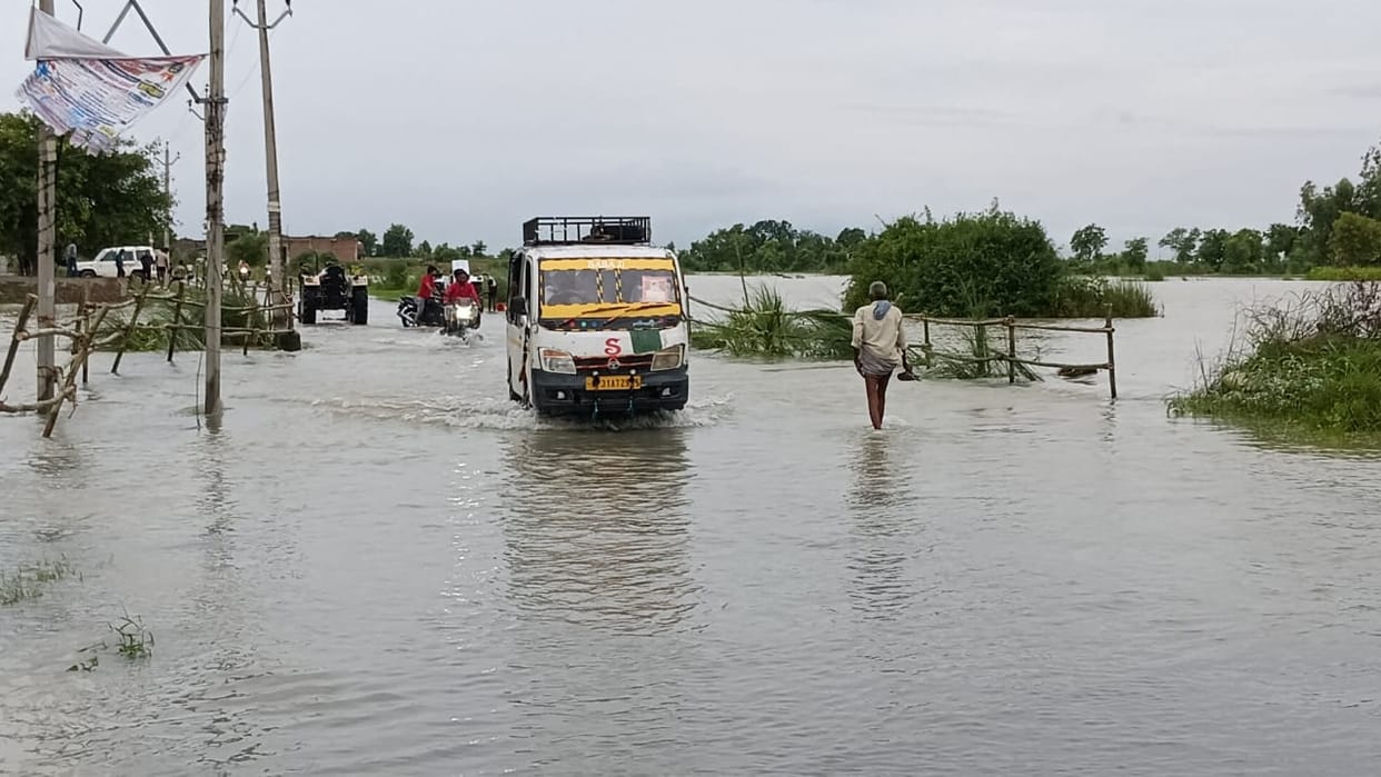 People wading through one-and-a-half feet of water on the state highway.