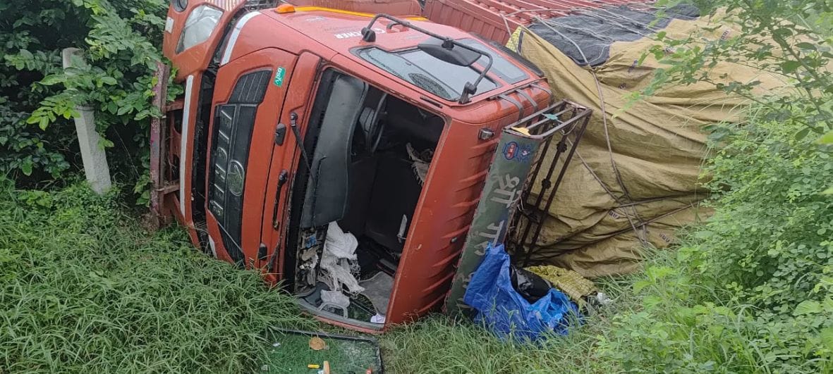 Out-of-control truck overturns on highway; driver and helper injured