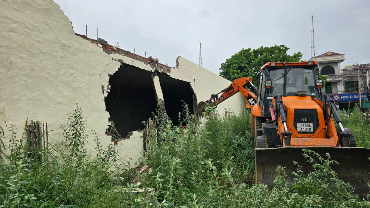 Illegal showroom demolished using a JCB.