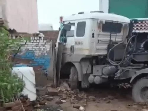 Out-of-control trailer truck crashes into house; car and house damaged, but no one injured.