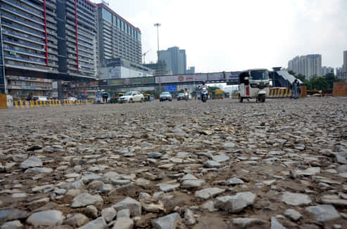 Road above underpass disintegrates within a year, causing traffic jams.