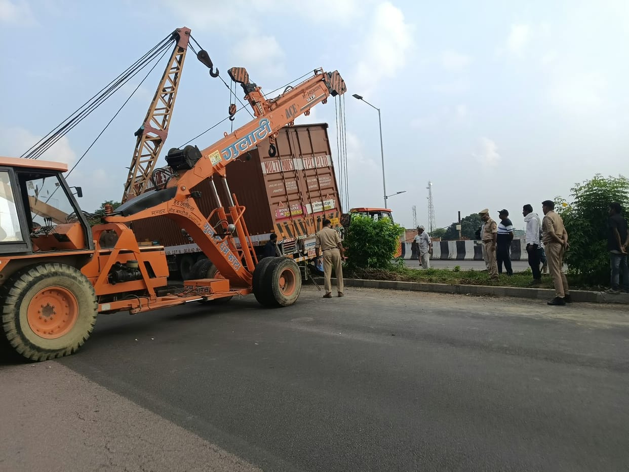 Container loses control and overturns on overbridge.