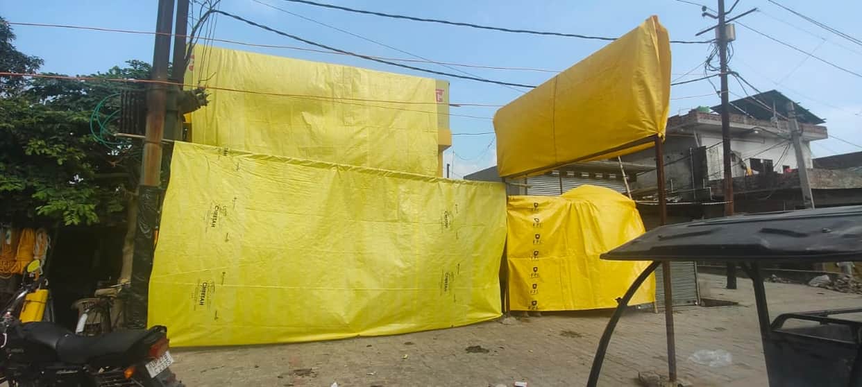 Liquor shops along the Kanwar route covered with tarpaulins.