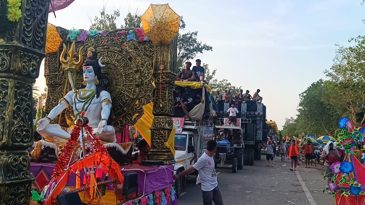 Kanwariyas welcomed with a shower of flowers from a bulldozer.