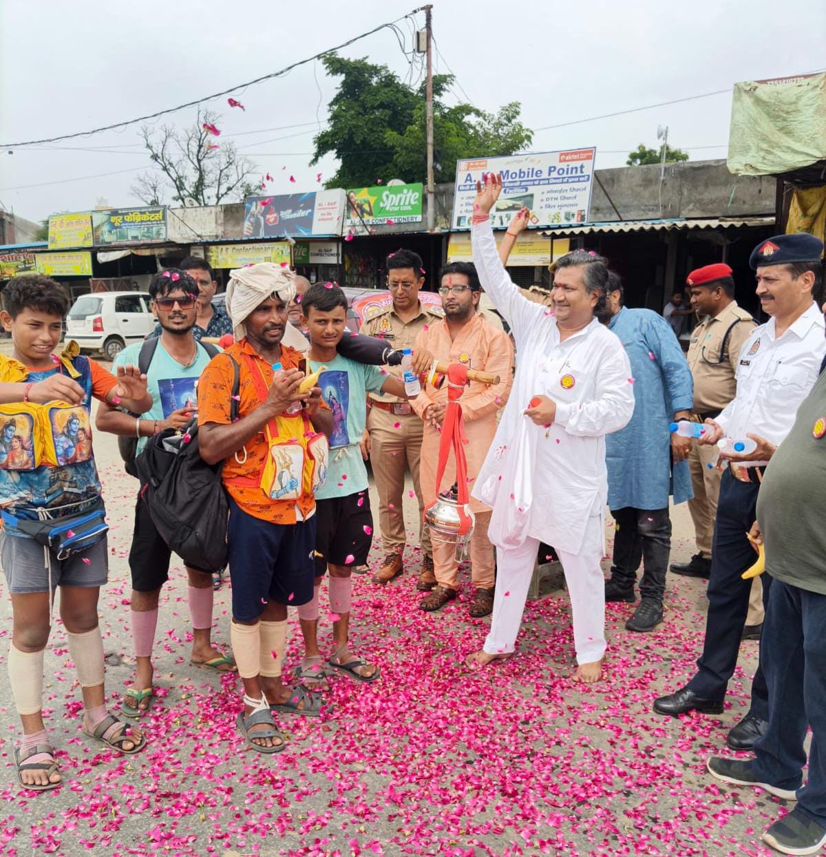 Flowers showered on Shiva devotees bringing Ganga water.