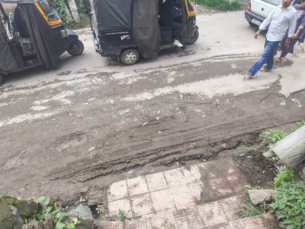 Pothole filled with soil; turned into a quagmire as soon as it rained.
